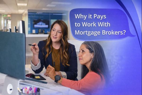 Two professional women discuss mortgage options at a desk in a modern office, reviewing information on a computer screen, with a speech bubble reading “Why it Pays to Work With Mortgage Brokers?” in Connect Mortgages’ branded colours.