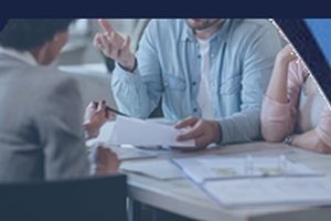 A branded graphic showing a couple sitting at a table speaking with a mortgage adviser and reviewing documents in a modern office. A dark blue speech bubble at the top reads “When Should I Seek Mortgage Advice?”, with curved blue corner accents.