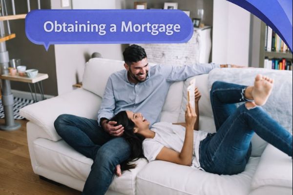 A couple relaxes on a white sofa in a bright living room, laughing while one person holds a phone. A blue speech bubble in Open Sans reads “Obtaining a Mortgage,” with curved blue Connect Mortgages brand accents in the top-right corner.