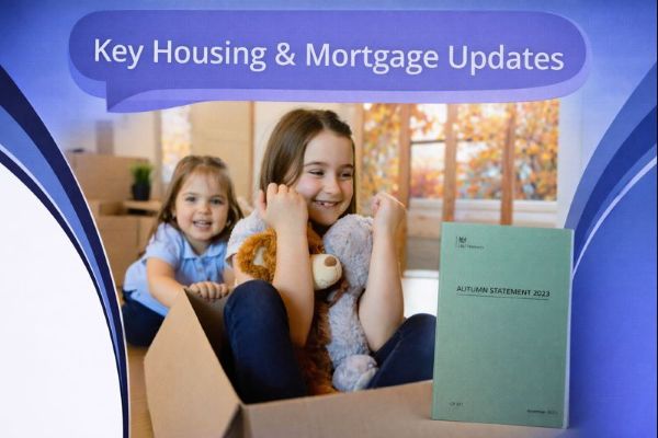 Blue branded graphic with a dark blue speech bubble reading “Key Housing & Mortgage Updates”. Below, two children sit in a cardboard box in a living room with moving boxes, with autumn-coloured trees visible through a window. On the right, a green booklet titled Autumn Statement 2023 is shown. Curved blue design elements frame the edges on a white background.