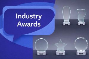 Industry Awards graphic showing six clear glass trophies on display, with a unique dark blue and light blue speech bubble containing Open Sans text “Industry Awards”.